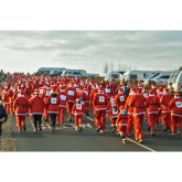 Sea of red and green as Santas and elves dash for charity cash