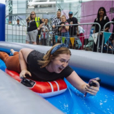 SLIDING INTO THE WEEKEND!  Media guests make a splash on 60 metre waterslide to launch Birmingham Weekender Festival