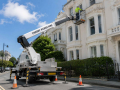 Cherry picker in use during property maintenance work at a commercial building in Eastbourne