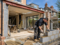 Professional builders carrying out construction and property improvement work at a building project in Eastbourne