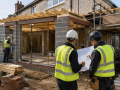 Building contractors managing a residential construction project in Eastbourne