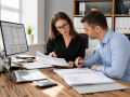 Business owner reviewing financial records with an accountant providing Accounting and Bookkeeping Services in Eastbourne.