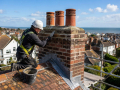 Roofing contractor carrying out Chimney Maintenance and Repairs in Eastbourne on a residential property.