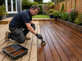 Professional Decking in Eastbourne service applying protective stain to timber decking after thorough preparation.