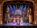 Visitors enjoying Entertainment Venues in Eastbourne during a live theatre performance at a historic venue.