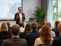 Professional delivering Public Speaking in Eastbourne to an engaged audience during a business presentation.
