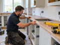Kitchen fitter installing cabinets in a kitchen in Eastbourne