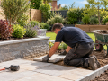 Landscape Gardeners in Eastbourne laying paving slabs as part of a garden landscaping project
